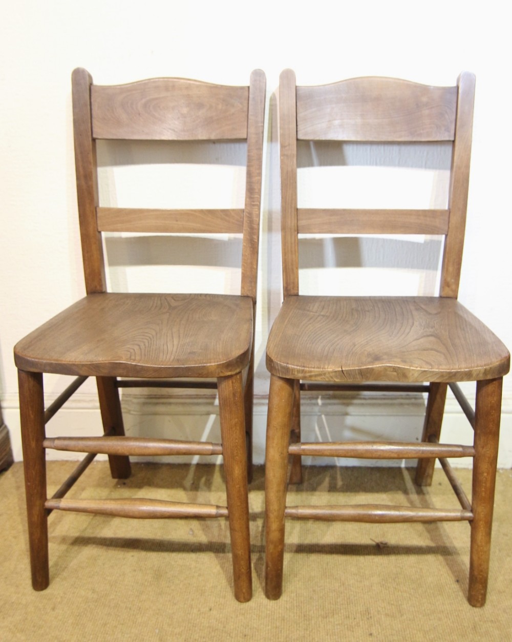 clean pair of light elm school chairs
